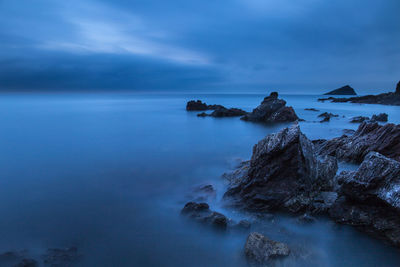 Scenic view of sea against cloudy sky