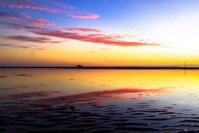 Scenic view of sea against romantic sky at sunset