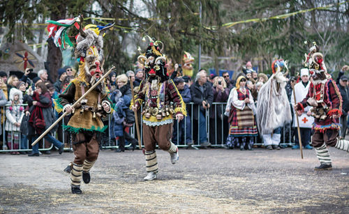 People wearing traditional costume during event