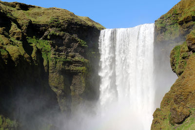 Scenic view of waterfall against sky. skogafoss.