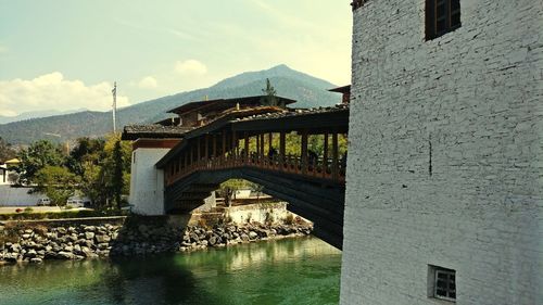 Arch bridge over water against sky