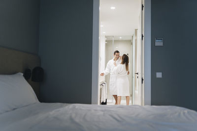 Woman lying on bed in bedroom