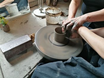 Midsection of person working in kitchen