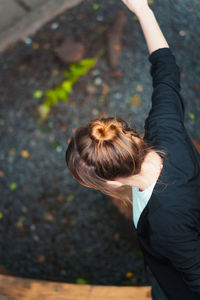 High angle portrait of woman with arms raised