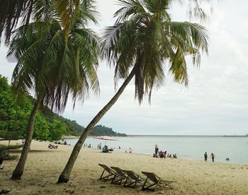 People on beach against sky