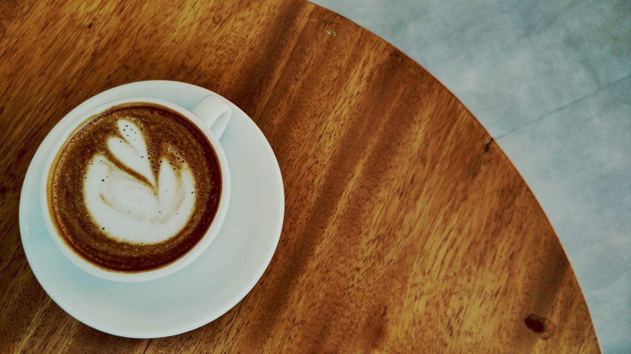 coffee cup, drink, food and drink, coffee - drink, refreshment, table, frothy drink, directly above, saucer, indoors, cappuccino, still life, high angle view, freshness, close-up, froth art, beverage, latte, brown, creativity, hot drink, no people, serving size