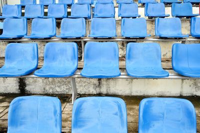 Full frame shot of empty blue seats in stadium