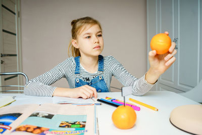 Portrait of a girl holding food at home