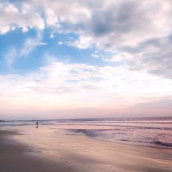 Scenic view of beach against sky during sunset