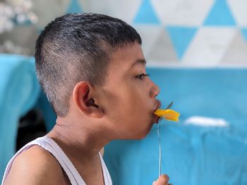 Side view of young man smoking