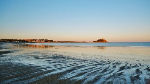 Scenic view of sea against clear sky during sunset