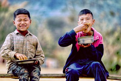 Portrait of boy sitting outdoors