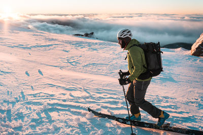 Snowboarder touring in backcountry during sunrise on mount hood
