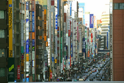 Panoramic view of illuminated street amidst buildings in city