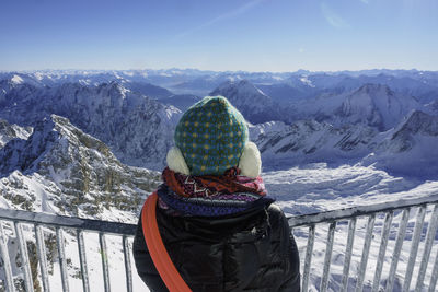 Person looking at snow covered rocky landscape