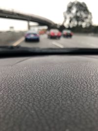 Close-up of car on road