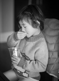 Girl having food while sitting on seat