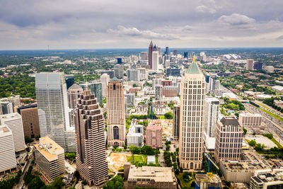 High angle view of modern buildings in city against sky