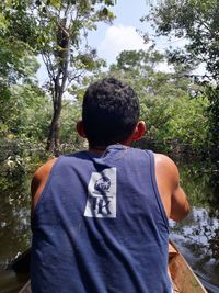 Rear view of man standing in forest