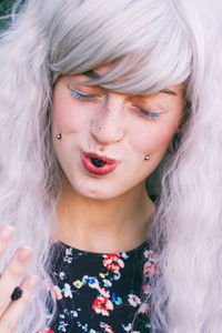 Close-up of female model eating blackberry