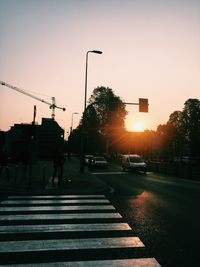 Traffic on road at sunset