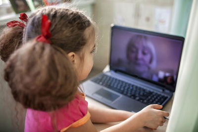 Side view of girl talking with grandmother