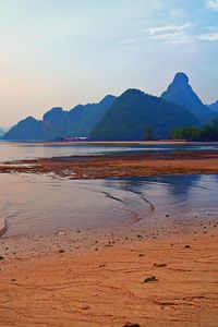 Scenic view of beach against sky during sunset