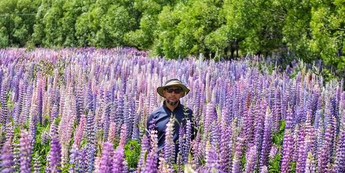 Full length portrait of man standing on lavender field