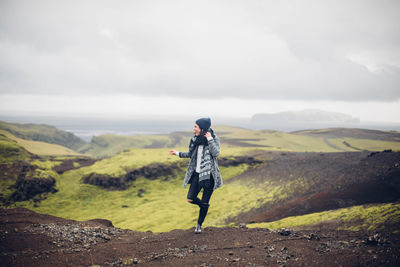 Man standing on landscape against mountain range