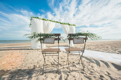 Signs on chairs during wedding at beach