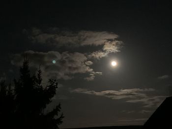 Low angle view of silhouette moon against sky at night