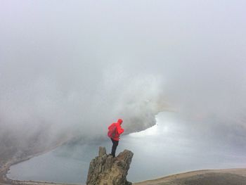 Rear view of man standing on mountain