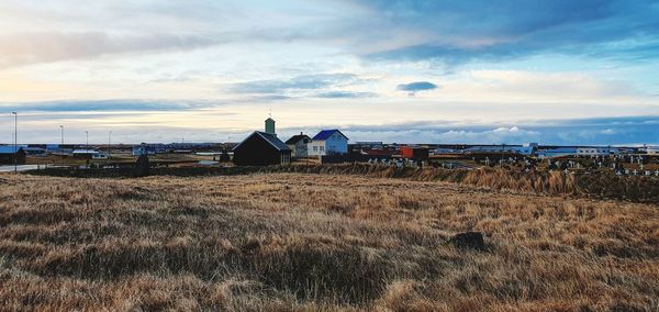 Houses on field against sky