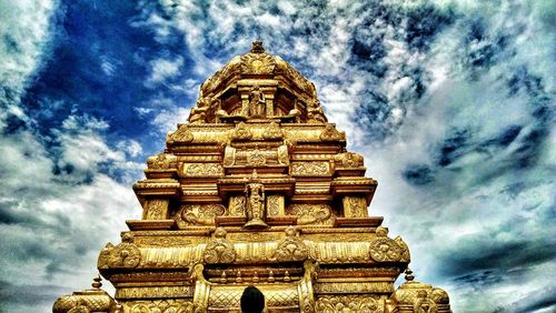 Low angle view of temple against cloudy sky