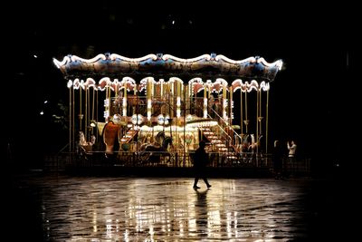 Illuminated carousel in amusement park