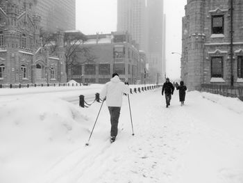 People walking on snow covered street