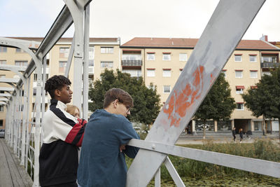 Teenage boys standing on bridge