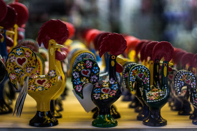 Colorful chicken bird figurines arranged at store for sale