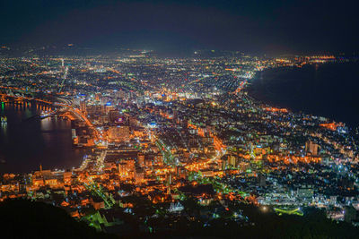 High angle view of illuminated buildings in city at night