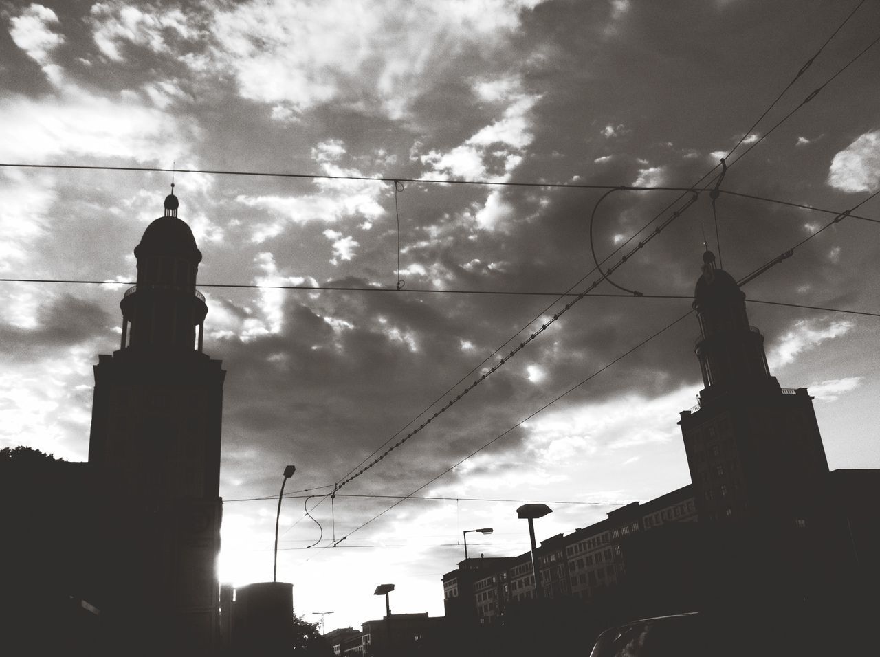 architecture, building exterior, silhouette, built structure, low angle view, sky, cloud - sky, power line, cloudy, cloud, cable, religion, sunset, building, dusk, church, no people, outdoors, city, high section