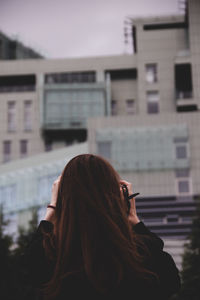 Rear view of woman standing in city