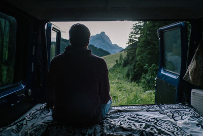 Rear view of man sitting in car