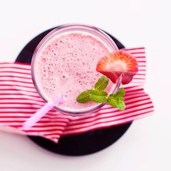 Directly above shot of strawberry smoothie in plate on table