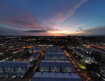 High angle view of illuminated cityscape against sky at night