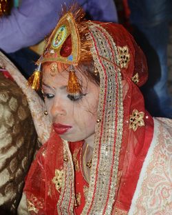 Close-up of bride in red sari during wedding ceremony