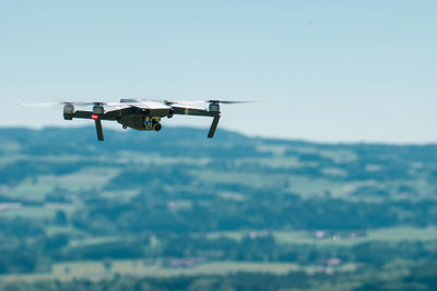 Drone flying against clear sky