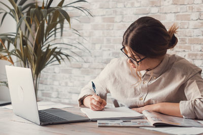 Young woman using laptop at office