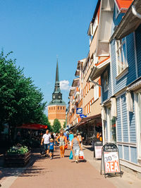 People walking on street by building