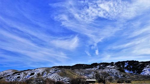 Low angle view of mountain against blue sky