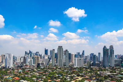 View of cityscape against cloudy sky